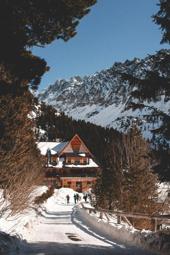 pexels-photo-7107529-7107529 Charming wooden chalet covered in snow surrounded by majestic mountains in Slovakia.